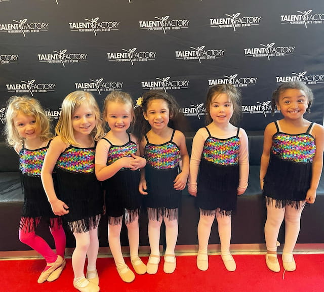 a group of girls in matching outfits