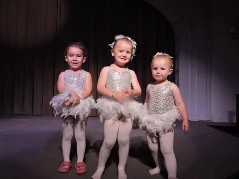 a group of girls in dresses
