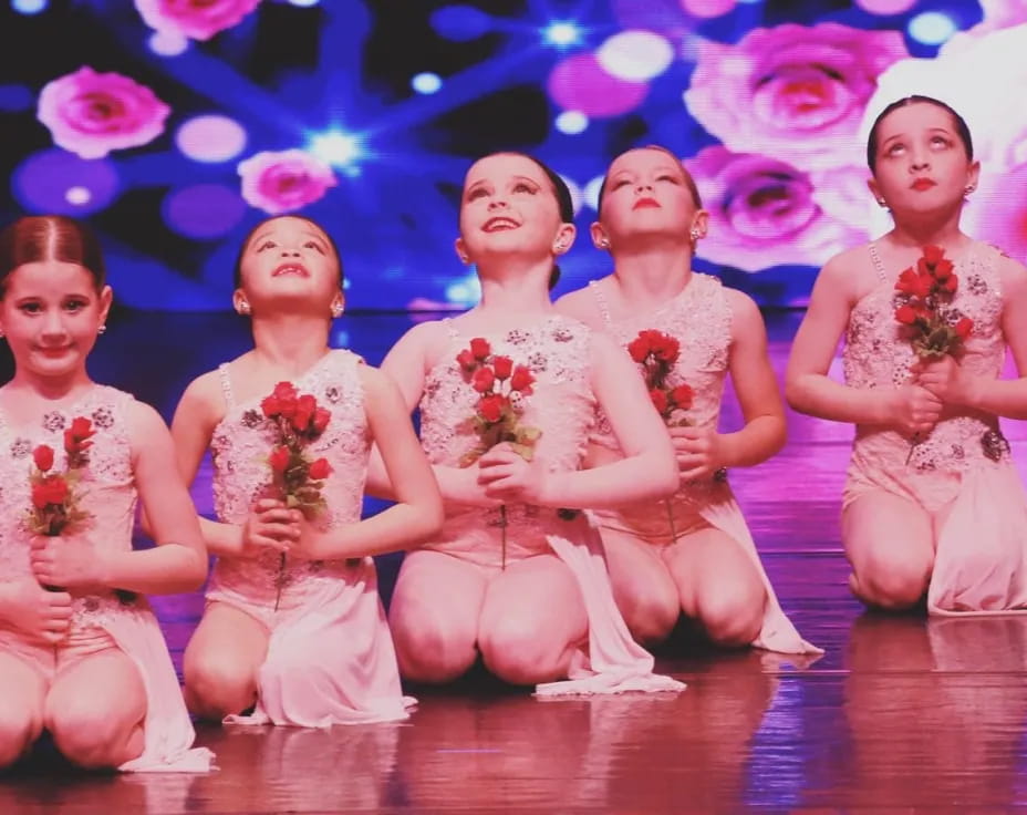 a group of women in pink dresses