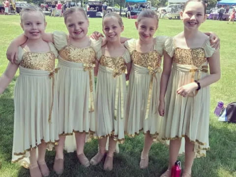 a group of girls in dresses