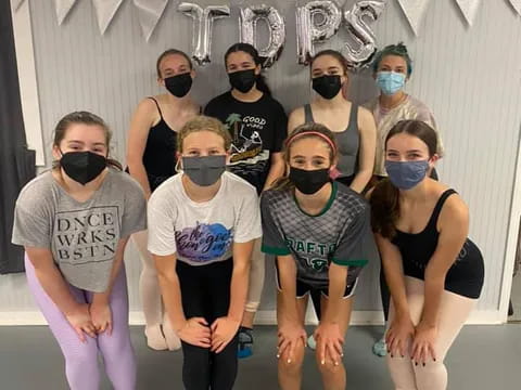 a group of people wearing masks