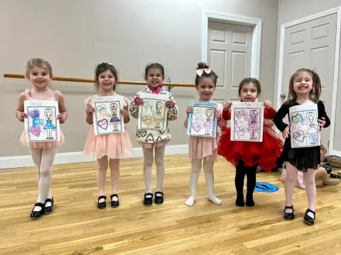 a group of children holding books