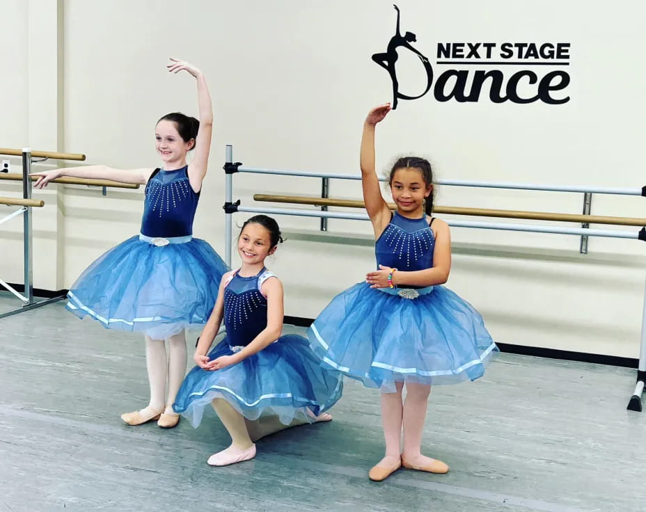 a group of girls in blue dresses