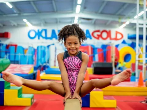 a girl on a mat in a gym