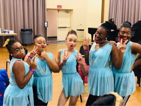 a group of girls in blue dresses