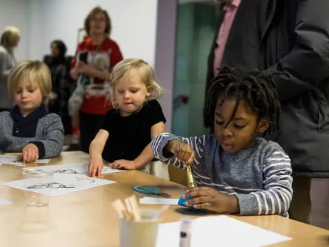 a group of children sitting at a table