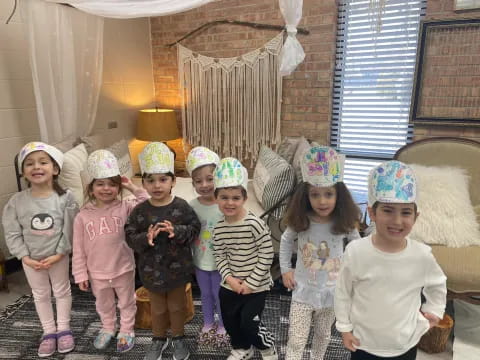 a group of children wearing party hats