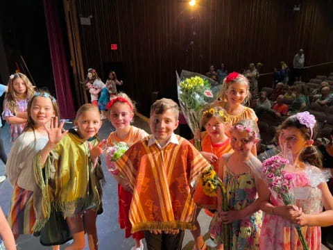 a group of children in colorful dresses