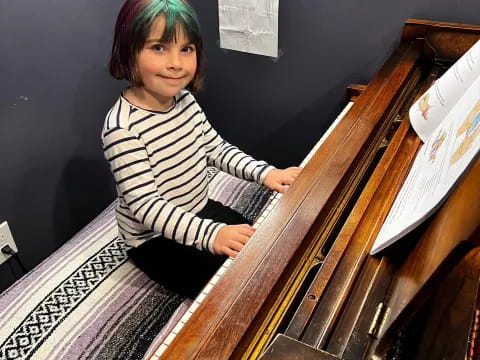 a girl sitting on a bench