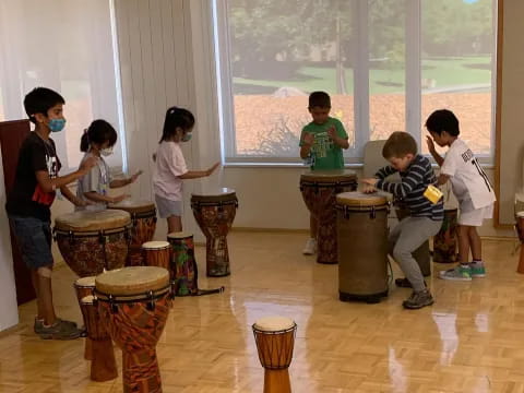 a group of kids playing drums