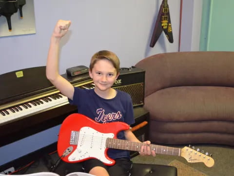 a boy playing a guitar