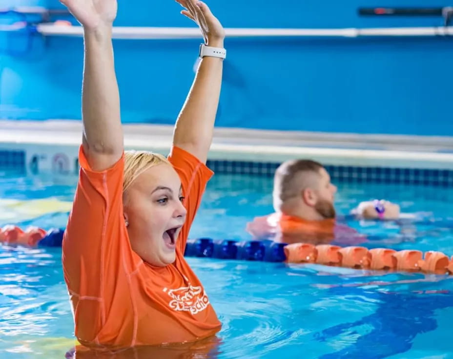 a couple of kids in a pool