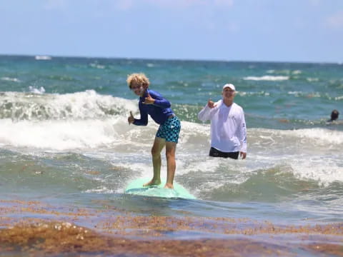 a man and a woman surfing in the sea