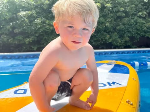 a boy sitting in a pool