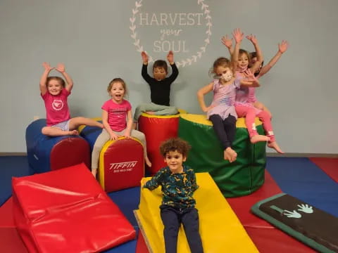 a group of kids sitting on colorful chairs