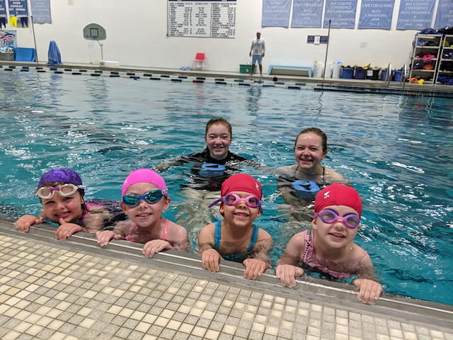 a group of kids in a pool