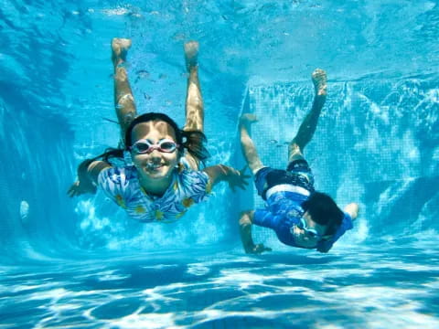a man and woman in a pool