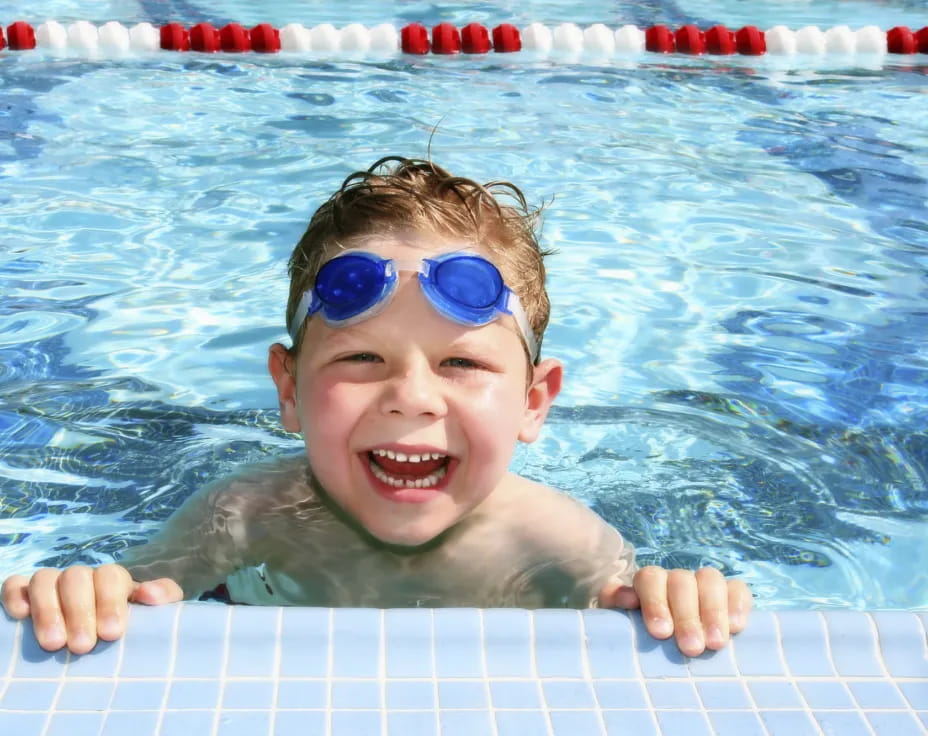 a baby in a pool wearing goggles