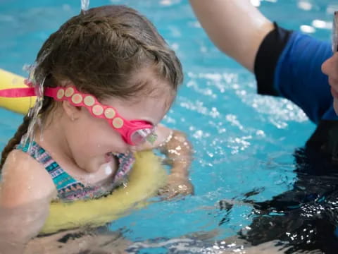 a person and a child in a pool