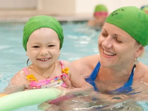 a person and a child in a pool