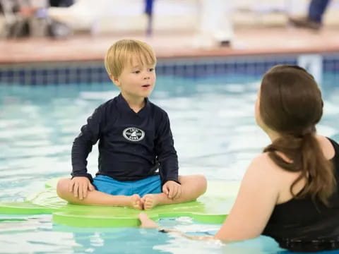 a person and a child in a pool
