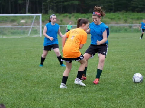 girls playing football on a field