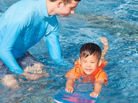 a man and a child in a pool