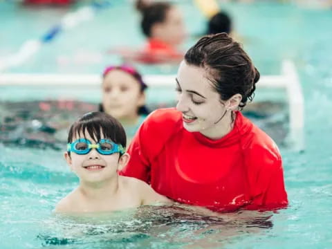 a person and a boy in a pool