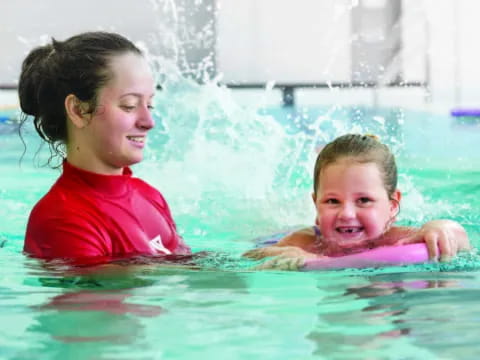 a person and a child in a pool