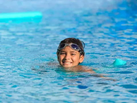 a boy swimming in a pool