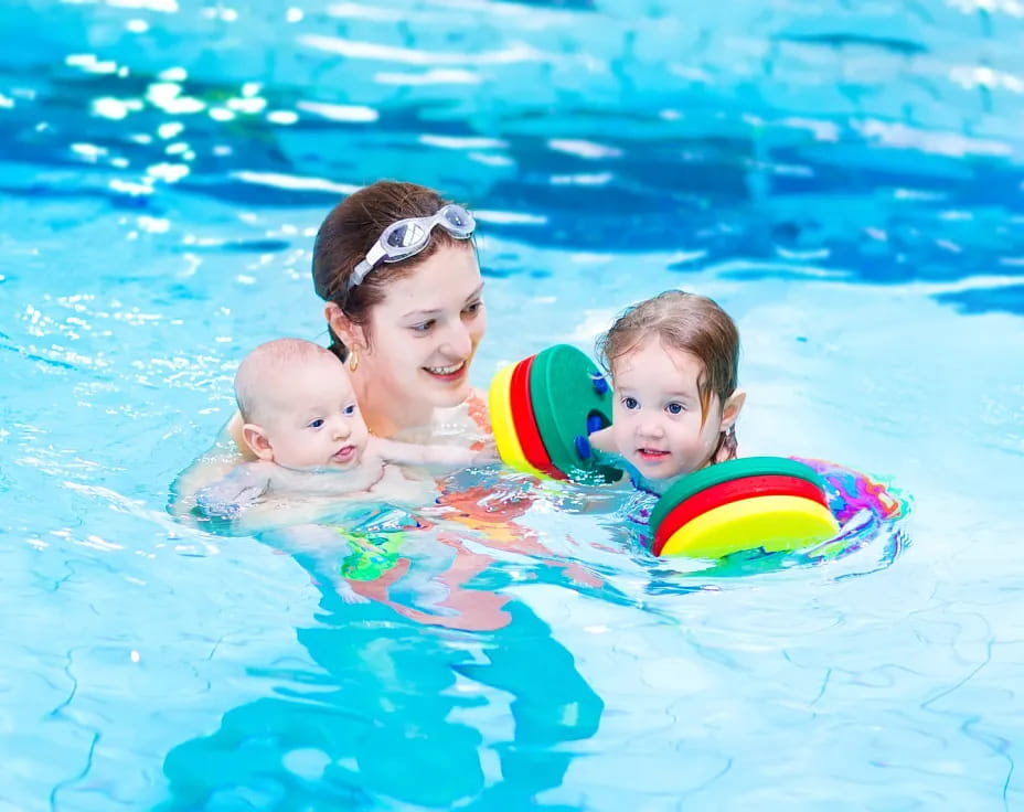 a person and two children in a pool