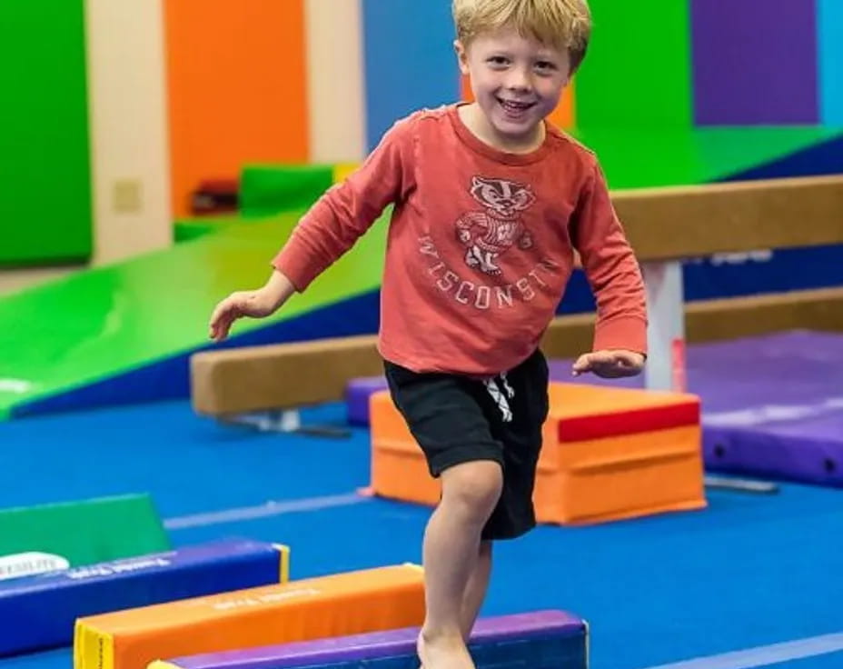 a boy standing on a mat