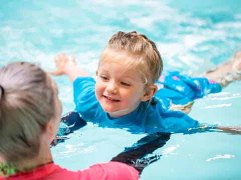 a boy and girl in a pool