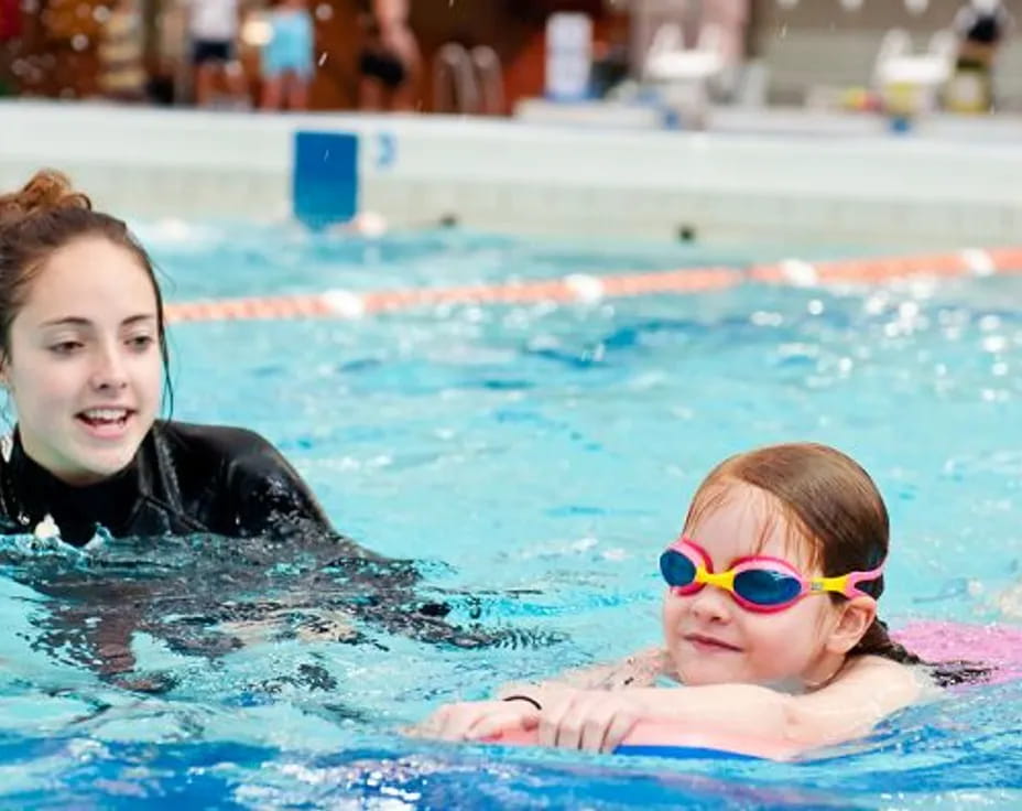 a person and a child in a pool