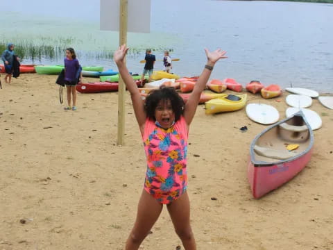 a girl holding a stick on a beach
