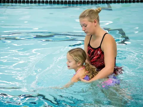 a woman and a child in a pool