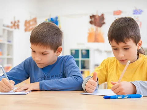 a few children sitting at a table