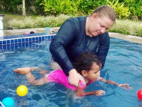 a person and a child in a pool