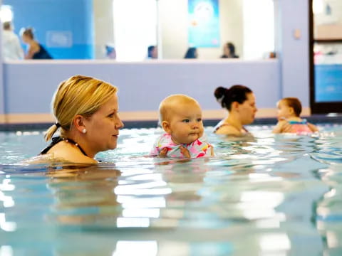 a person and a baby in a swimming pool