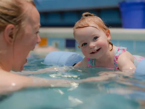 a woman and a child in a pool