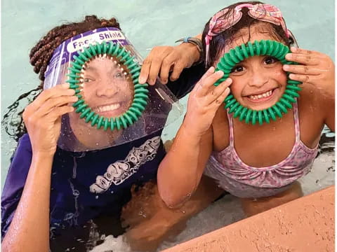 a person in a pool holding a cd