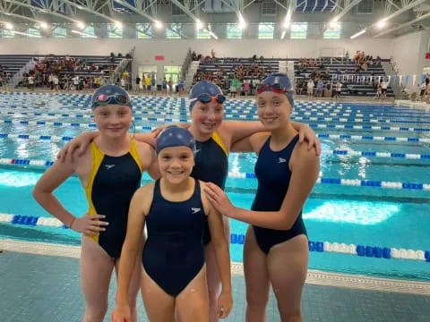 a group of women in swimsuits in a pool