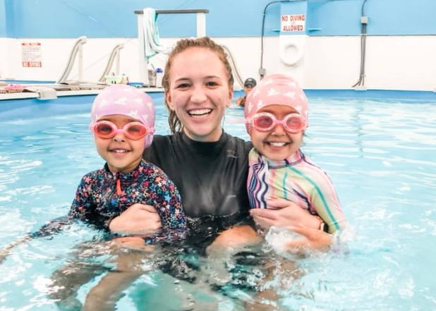 a person and two children in a pool