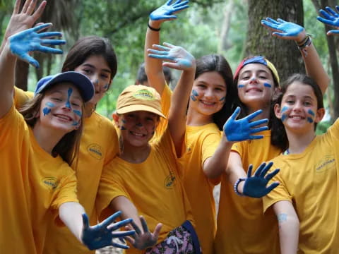 a group of girls wearing yellow shirts and blue gloves
