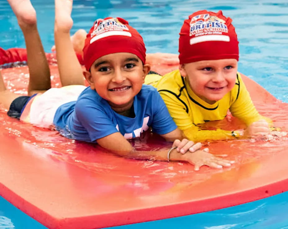 a couple of kids in a pool