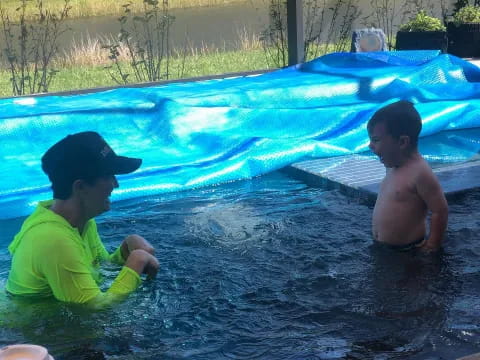 a man and a boy in a pool