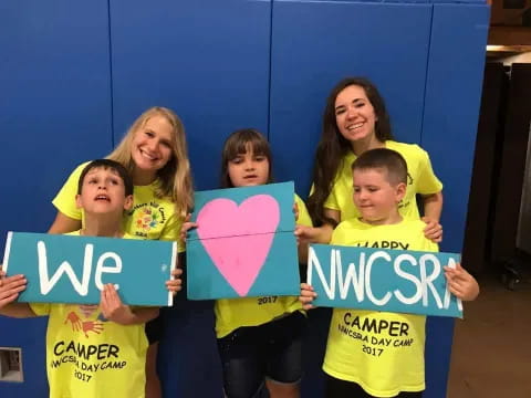 a group of children holding signs
