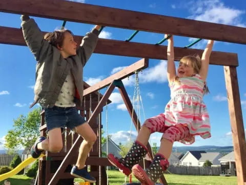 a person and a child on a swing