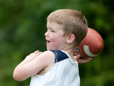 a boy throwing a ball