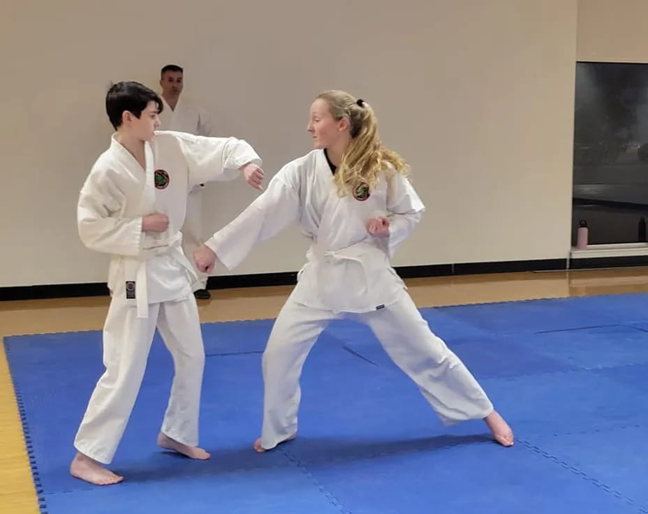 a man and a woman in karate uniforms